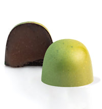 rosemary caramel chocolate infused bonbon cut open to show filling